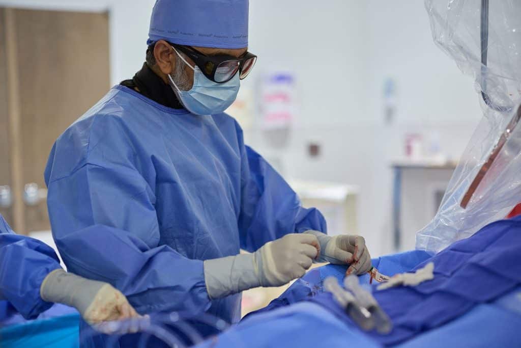 Surgeon performing a minimally invasive catheter procedure in an operating suite for the Structural Heart Program