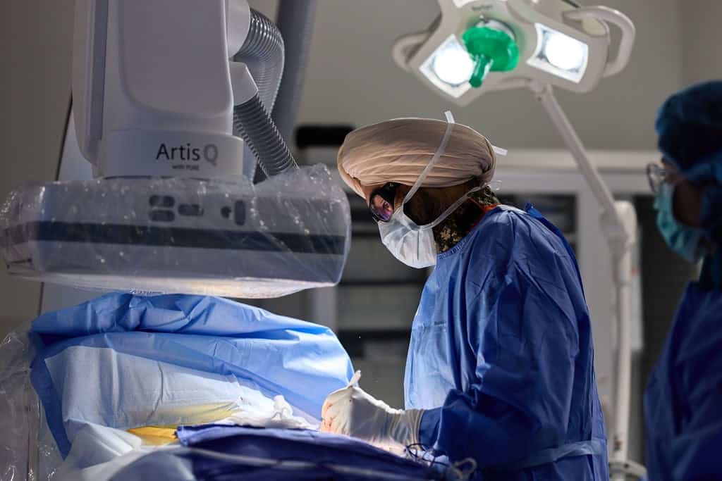 Cardiac electrophysiologist performing a catheter-based procedure under fluoroscopic imaging in an operating suite for Cardiac Ablations