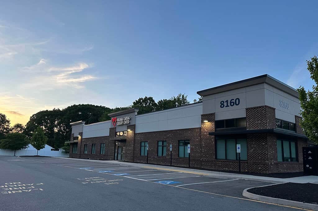 Exterior view of the medical office building and parking lot under a sunset sky for Ambulatory Surgery Center